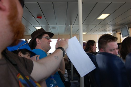 Joel hands out barf bags on the boat ride to Robben Island
