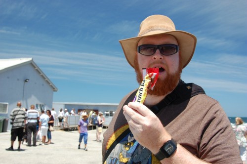 Joel eats a Lunchbar on Robben Island